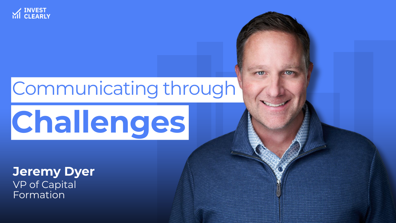 A promotional graphic for Invest Clearly featuring Jeremy Dyer, VP of Capital Formation. The text reads “Communicating through Challenges.” Jeremy is smiling and wearing a blue zip-up sweater over a light patterned shirt against a blue gradient background with subtle geometric shapes and the Invest Clearly logo in the top left corner.